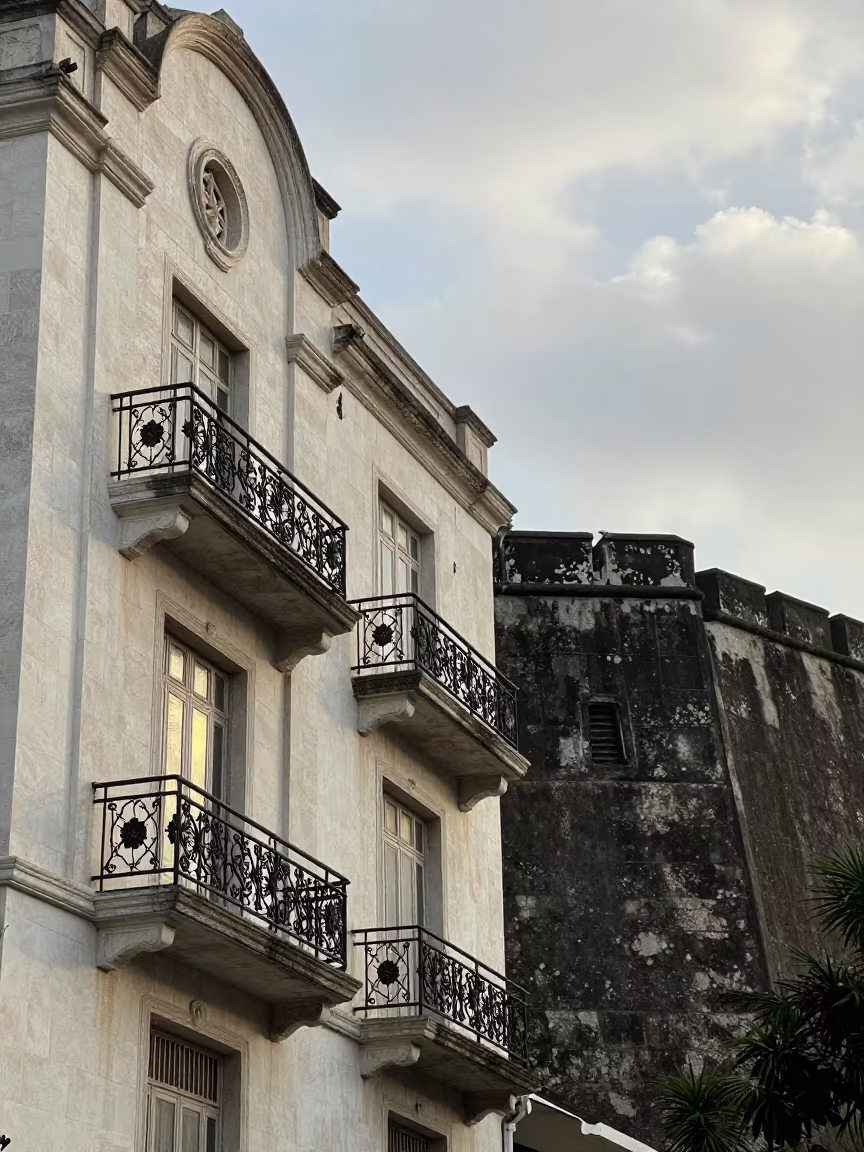 Art Nouveau Facade Reflecting Water Light in outside a wind-scoured fortress wall in Dar es Salaam