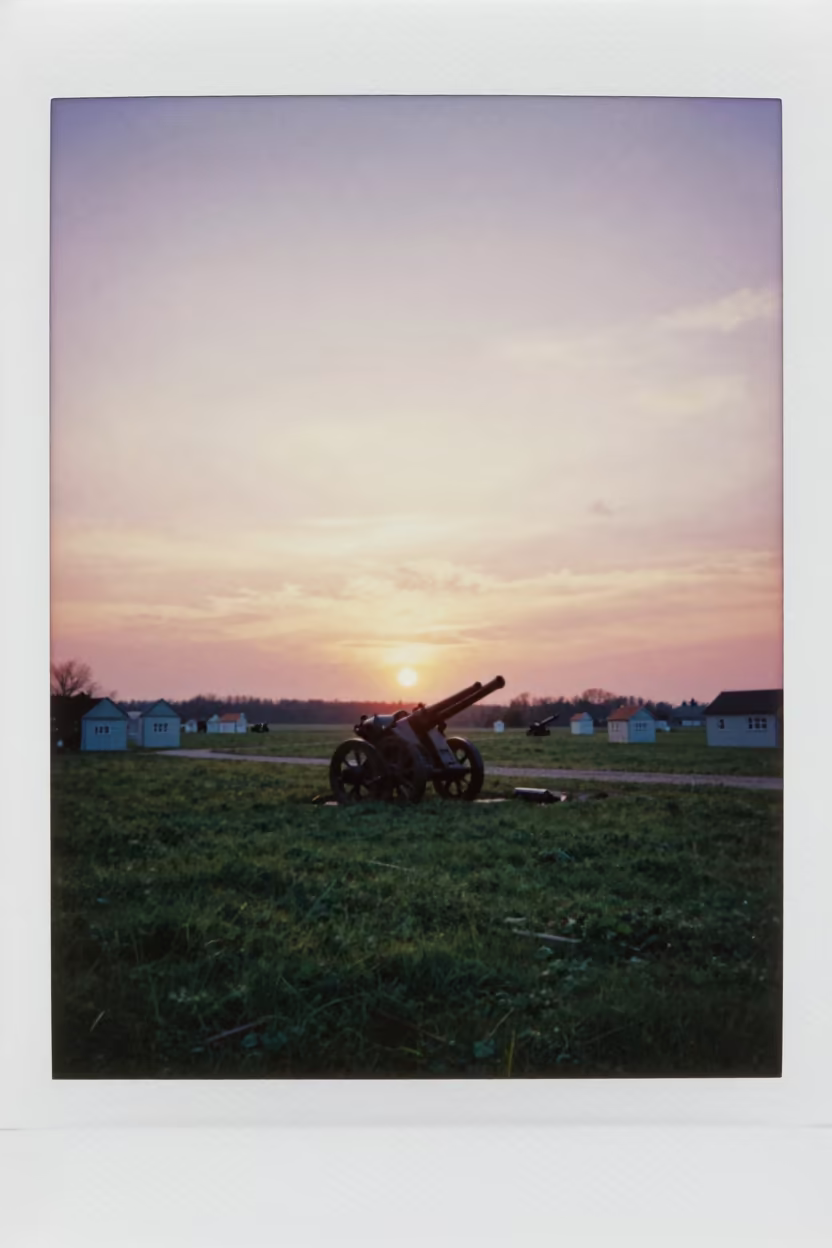 Artillery Silhouette Against Copper Sunset Ridge in on a parade ground in Austria