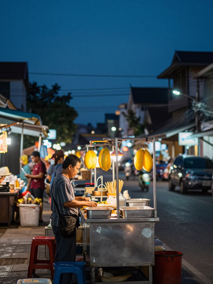 As City Lights Begin To Glow on Papaya Salad in Chiang Mai in in Chiang Mai, Thailand