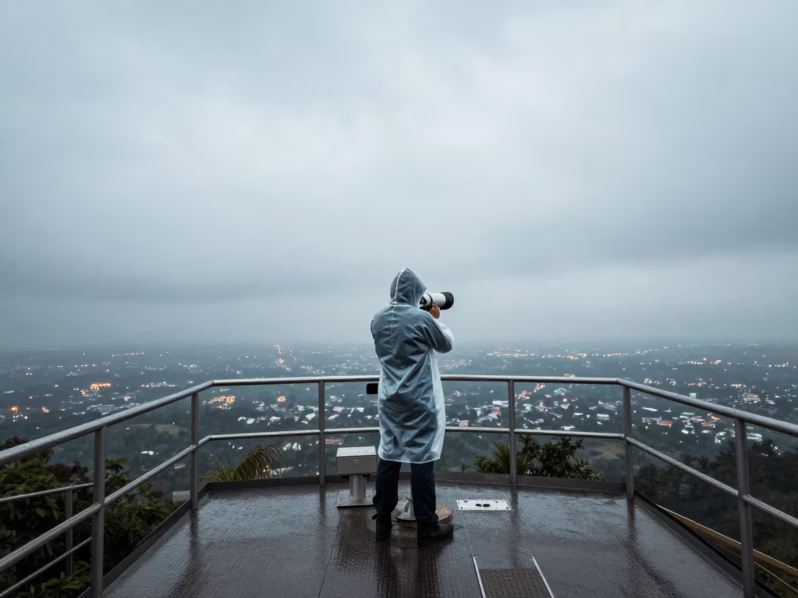 Astronomer observing city lights from rainy research platform in on a wind-scoured research platform in Mira-Bhayandar