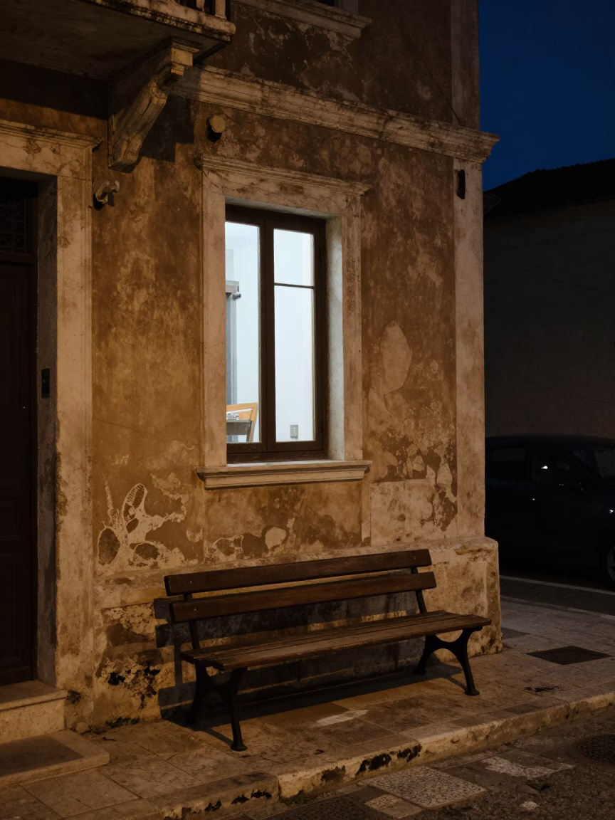 Athens Greece Night Street Scene with Window Light on Bench and Distant City Glow in in Athens, Greece
