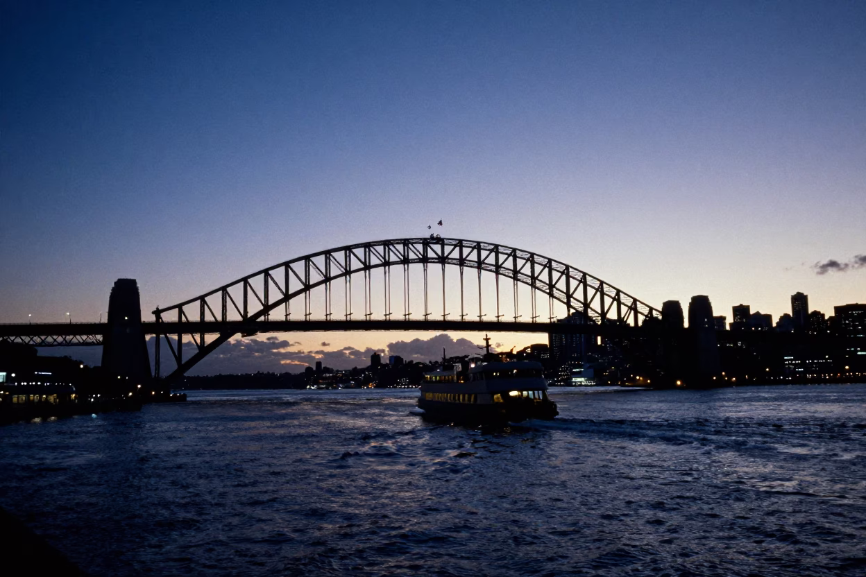 Auckland Harbour Bridge Silhouette and Ferry Wake in Pre-Dawn Light in in Auckland, New Zealand