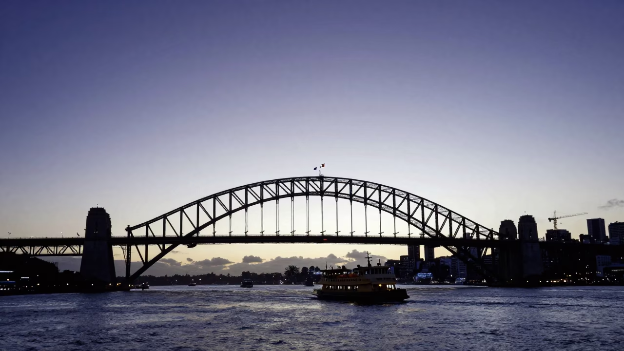 Auckland Harbour Bridge Silhouette at Nautical Dawn with Ferry and Urban Skyline in in Auckland, New Zealand