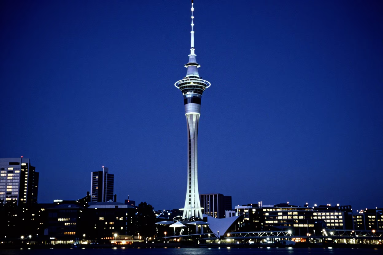 Auckland Sky Tower and Harbour Bridge illuminated during blue hour twilight in in Auckland, New Zealand