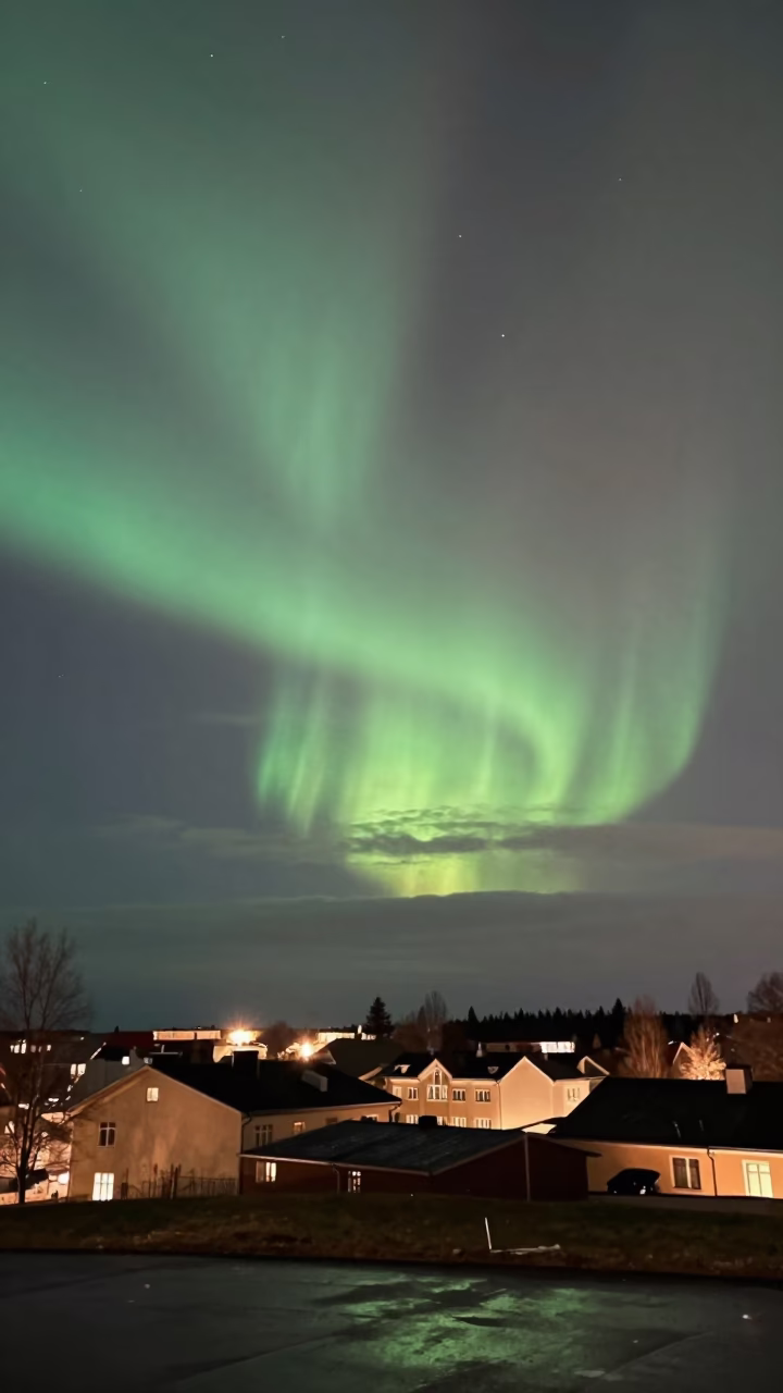 Aurora Curtains Over Punavuori Fjord Village in under a band of cold starlight near Punavuori, Helsinki