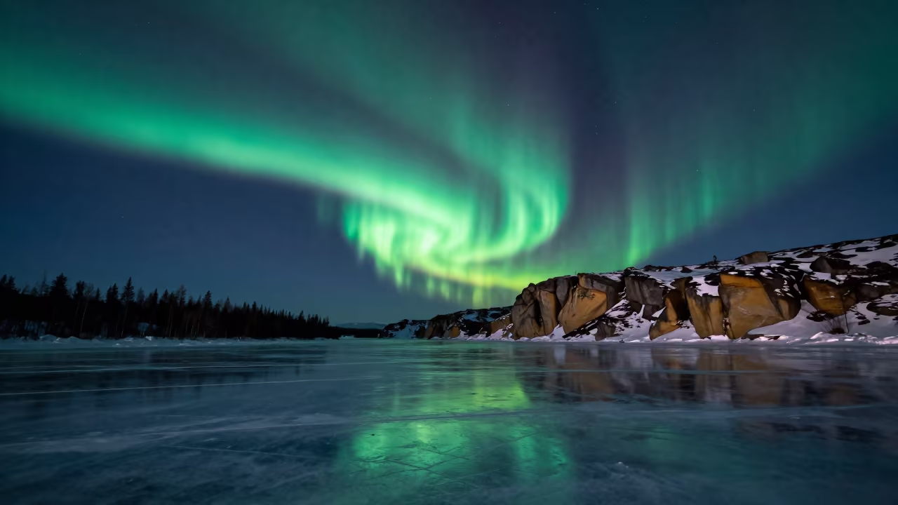 Aurora Waves Over Frozen Finnish Tundra Lake in beneath a wind-cut desert escarpment in Finland