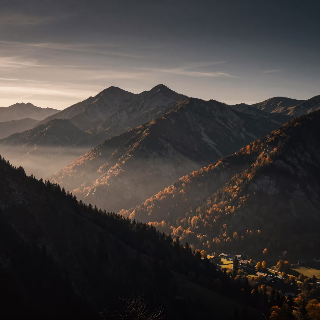 Austrian Mountain Ridge Silhouette in Predawn Mist in across a wide valley floor in Austria
