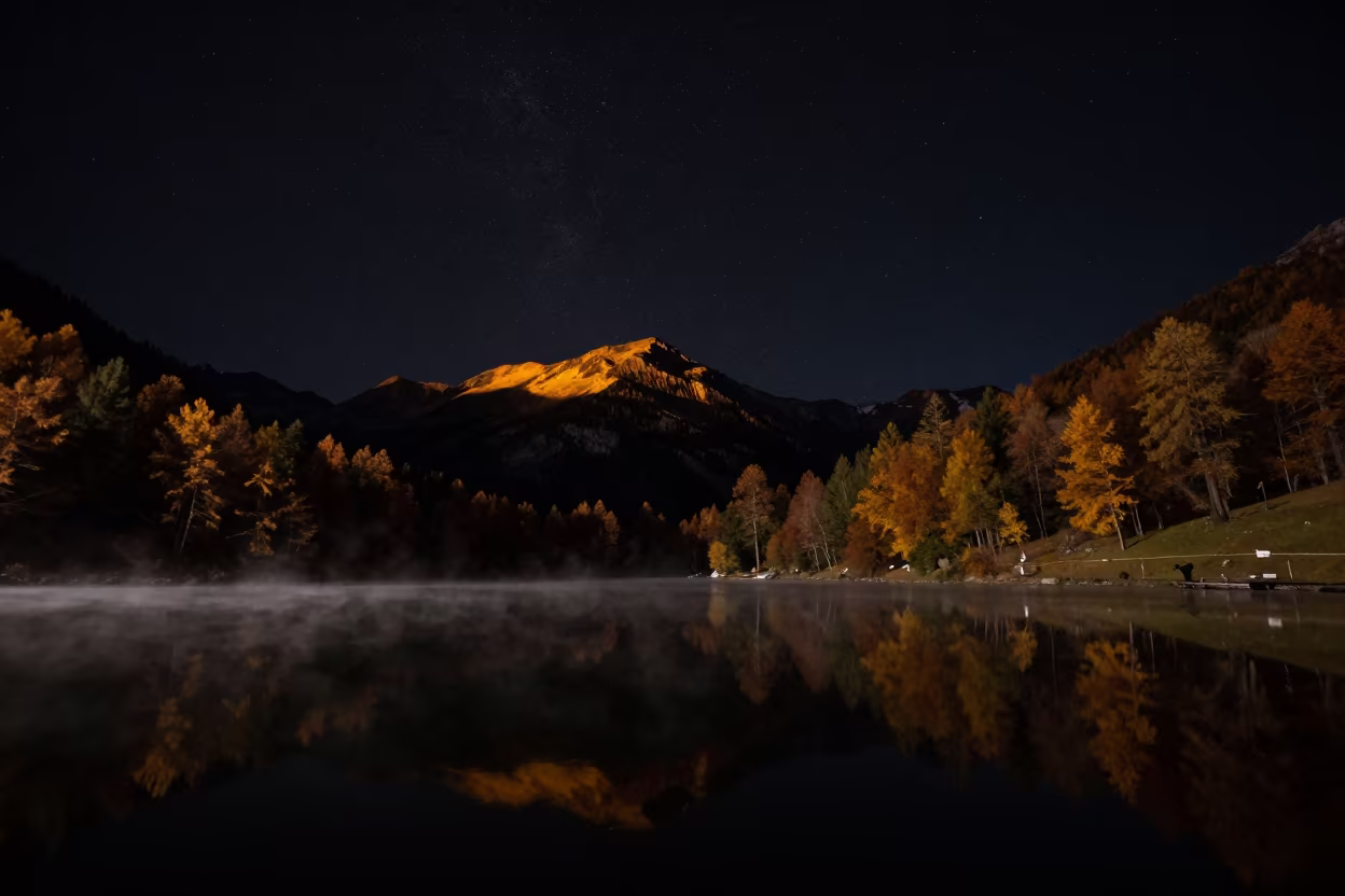 Autumn Mountain Tarn Reflecting Stars in Swiss Mist in beneath a dark-sky overlook in Switzerland