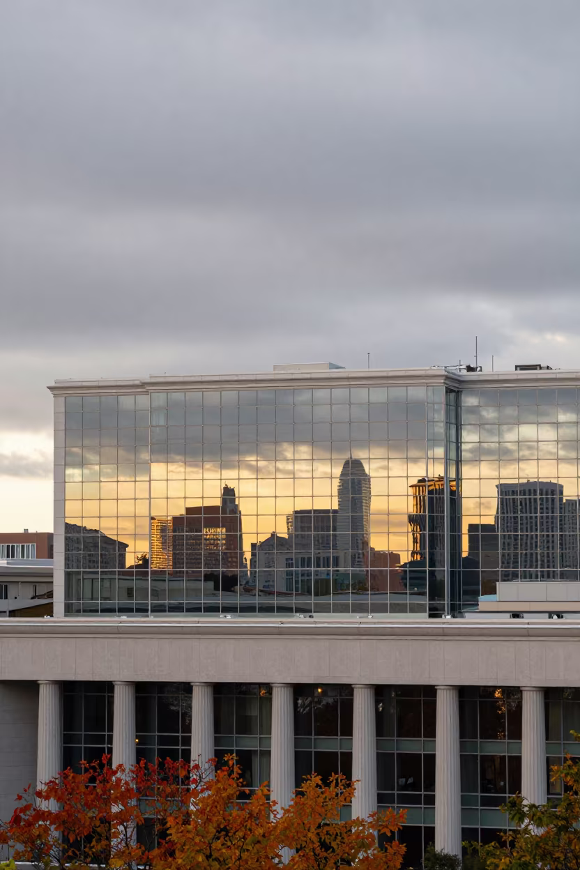 Autumn Sunset Reflection on Glass Facade in along a colonnaded facade near Victoria