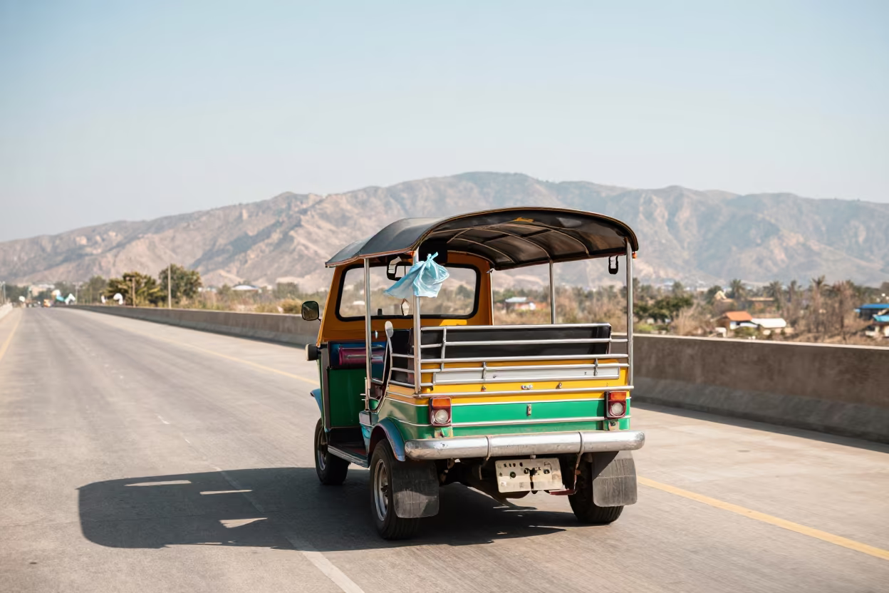 Bangkok Tuk-Tuk on Causeway at Noon in on a wind-open causeway in Thailand