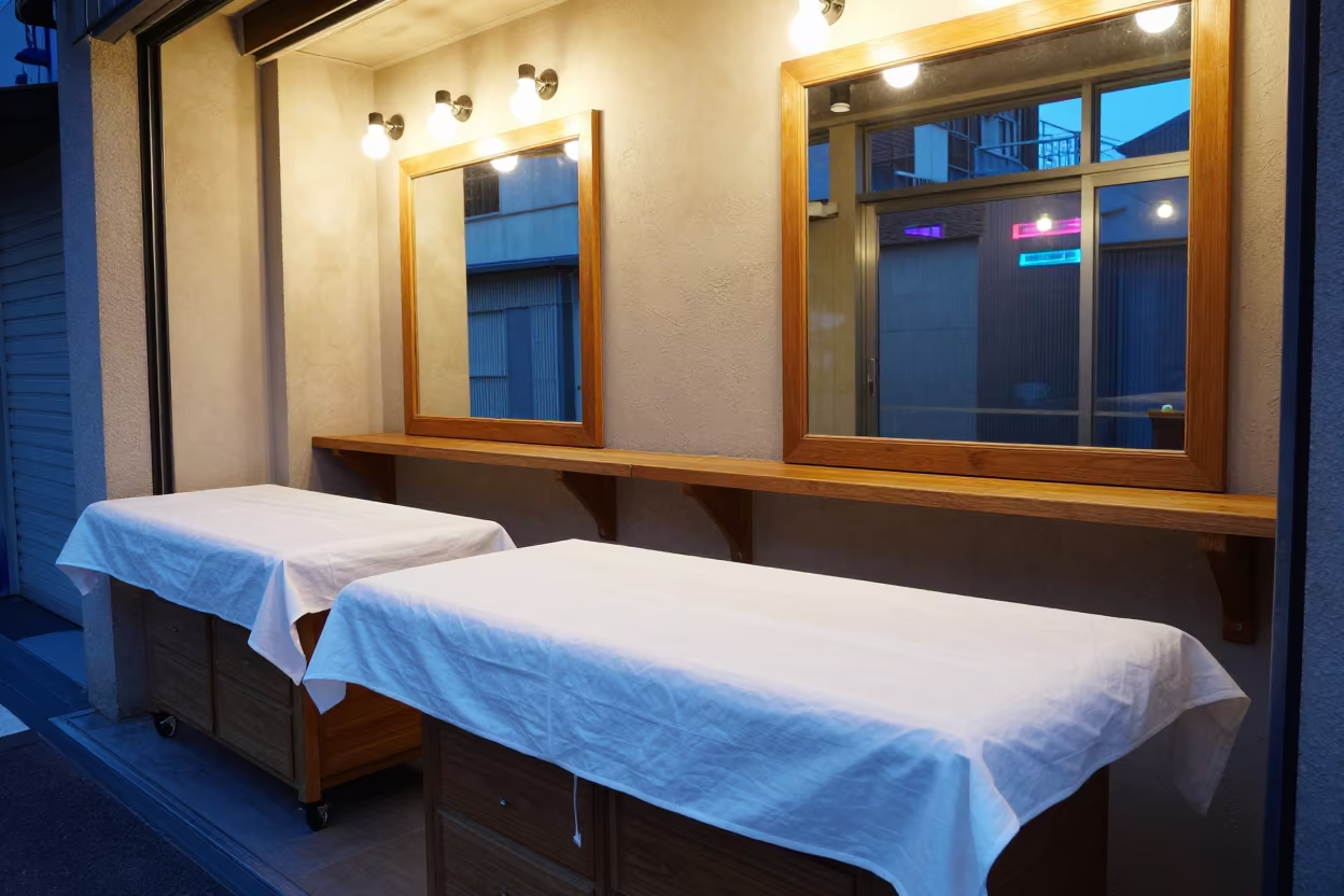 Barber Station Linen Sheet Under Neon Glow in at a barber station beneath mirror bulbs in Hiroshima