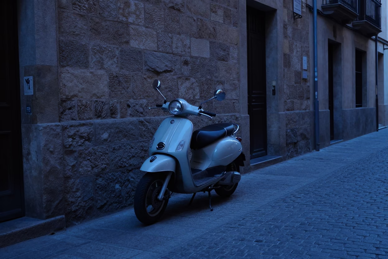 Barcelona Spain Pre-Dawn Street Scene with Vintage Motorcycle and Cobblestone Alley in in Barcelona, Spain