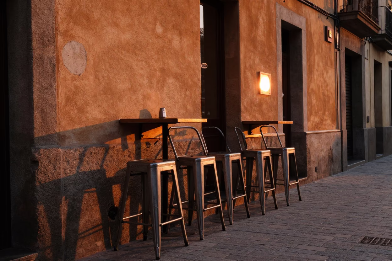 Barcelona Spain Sunset Street Scene with Bar Stools and Orange Tree in in Barcelona, Spain