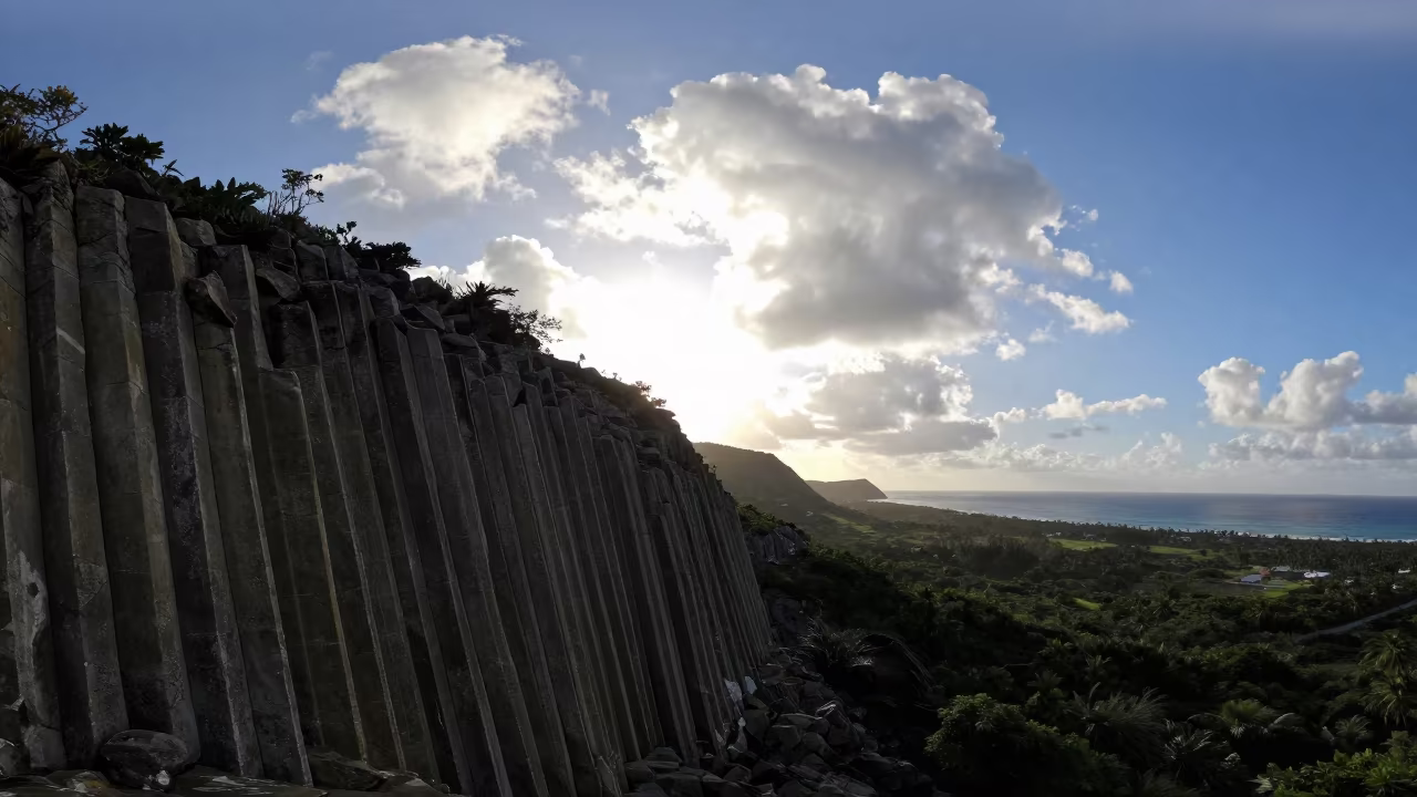 Basalt Organ Pipes Silhouetted Against Clouds in across a wide valley floor in Cuba
