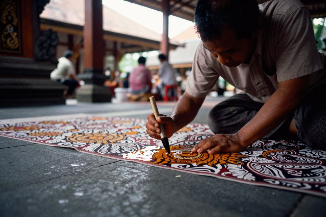 Batik Artist Applying Wax in Balinese Prayer Hall in in a prayer hall near Denpasar