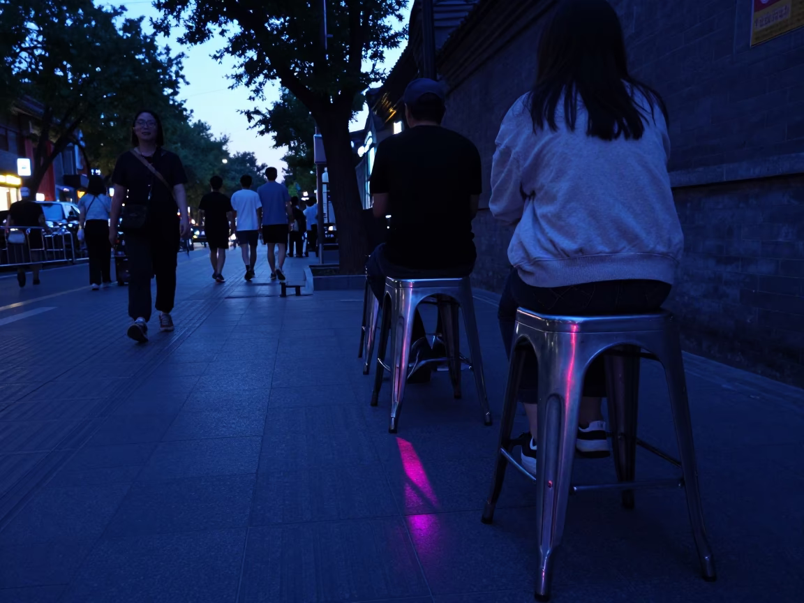 Beijing Blue Hour Street Scene with Metal Stools and Neon Reflections in in Beijing, China
