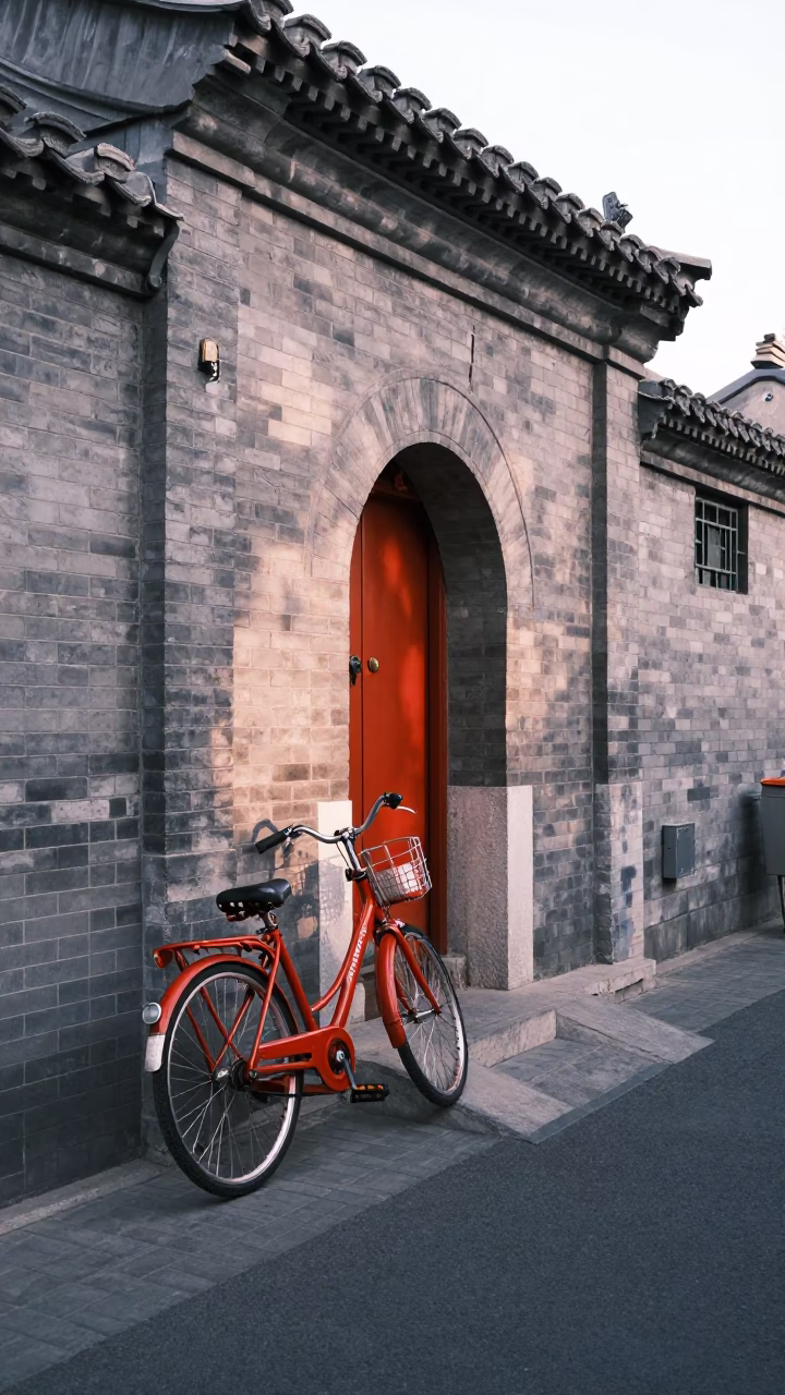 Beijing Street Scene at Dawn with Red Bicycle and Stone Archway in in Beijing, China