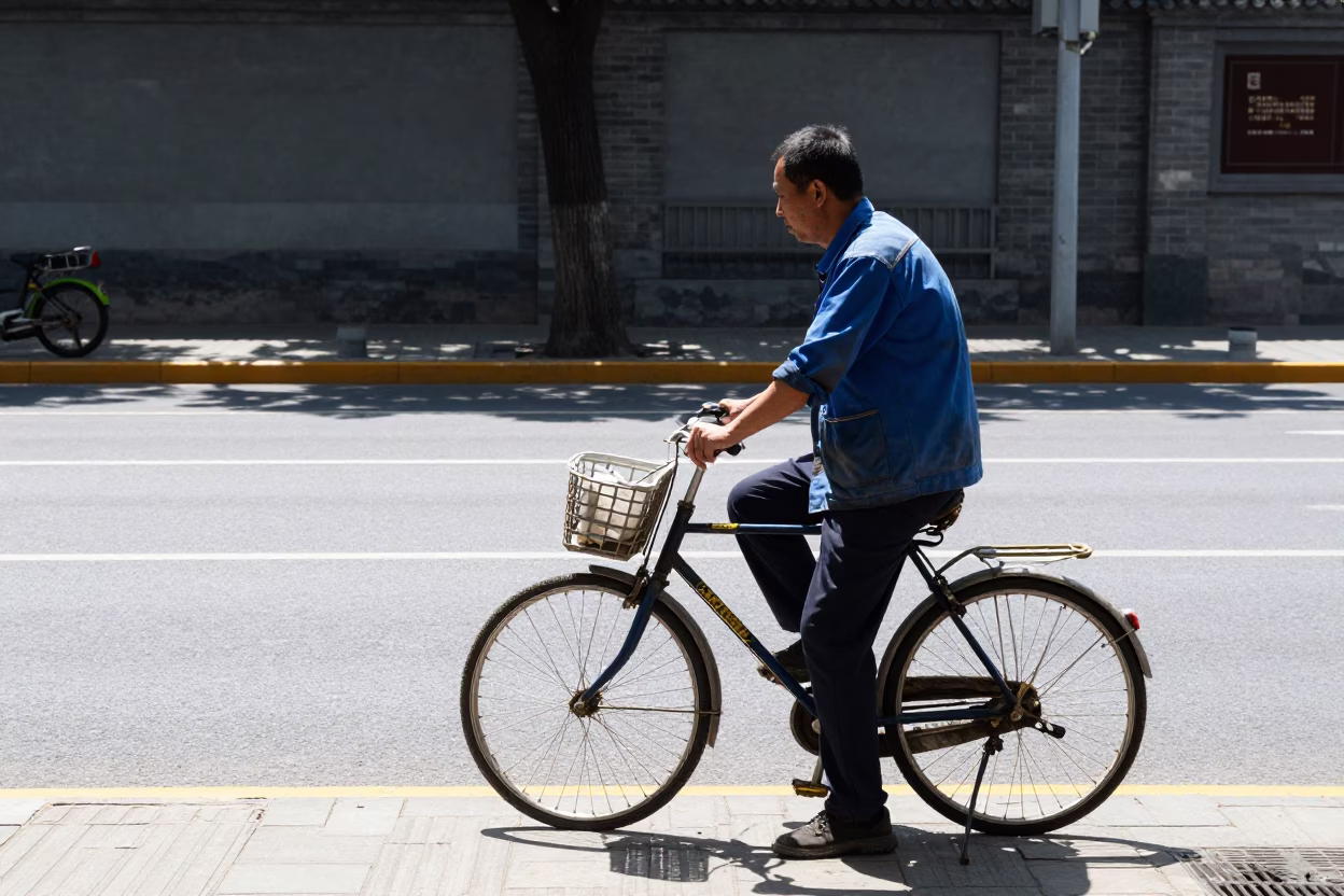 Beijing street scene noon light with worker and bicycle near traditional architecture in in Beijing, China