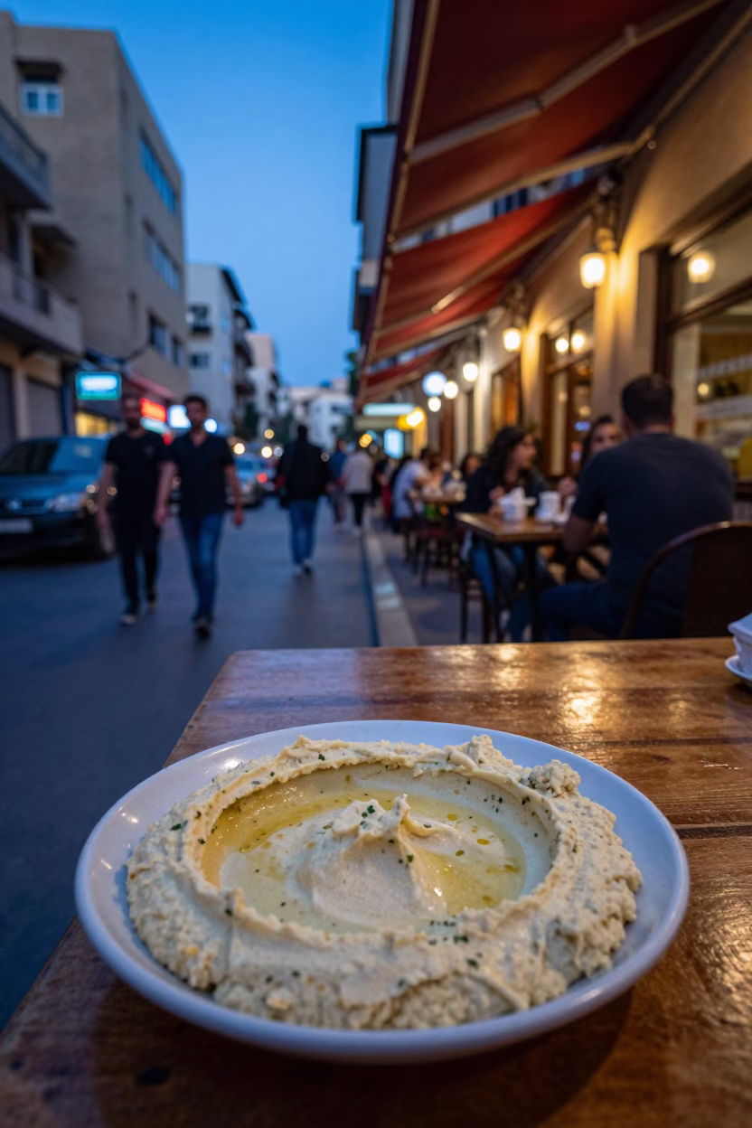 Beirut Evening Street Scene with Hummus Spread and City Lights in in Beirut, Lebanon