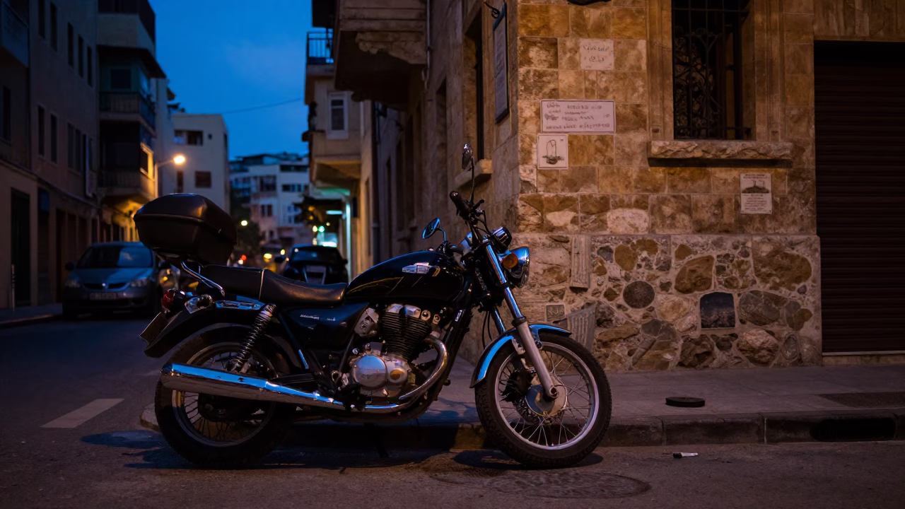 Beirut indigo twilight street scene with parked motorcycle and coastal mountains in in Beirut, Lebanon