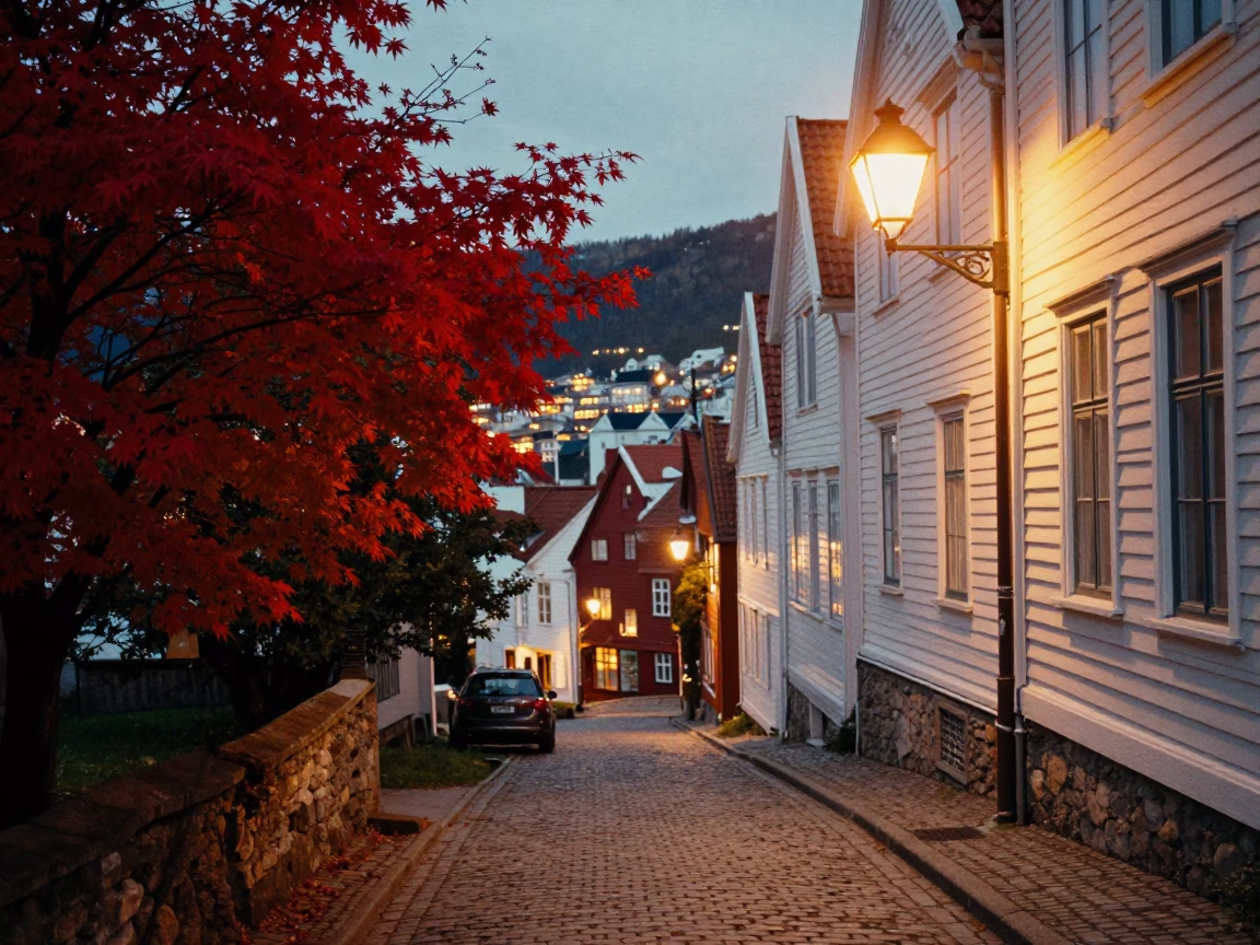 Bergen Norway Evening Street Scene with Red Japanese Maple and Cobblestone Alley at Dusk in in Bergen, Norway