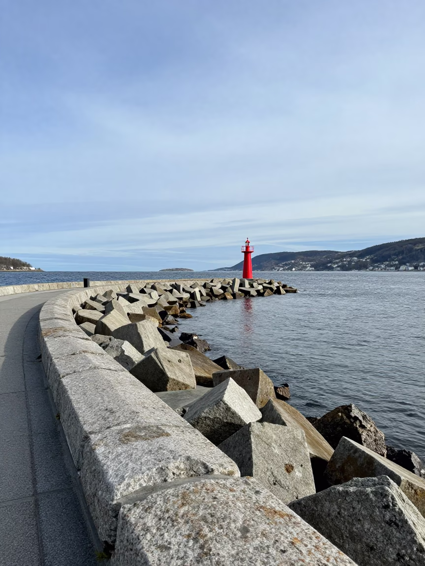 Bergen Norway Midday Harbor Breakwater Curve and Beacon with Local Activity in in Bergen, Norway