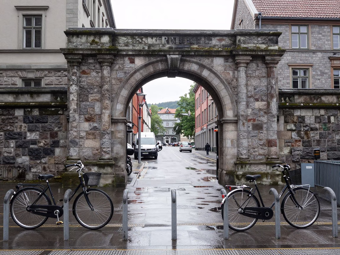 Bergen Norway Noon Street Scene with University Archway and Wet Bicycle Rack in in Bergen, Norway