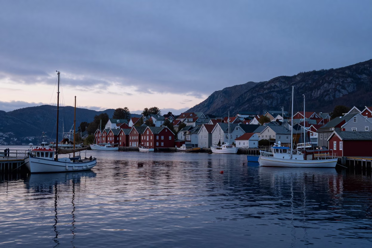 Bergen Norway Pre-Dawn Harbor View with Traditional Boats and Fjord Mountains in in Bergen, Norway