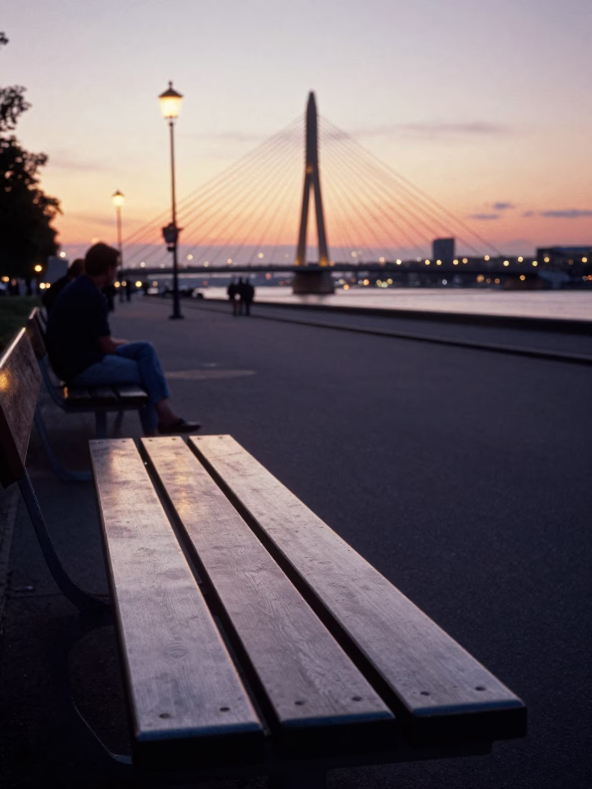 Berlin Sunset Street Scene with Brushed Steel Bench and Cable-Stayed Bridge Background in in Berlin, Germany