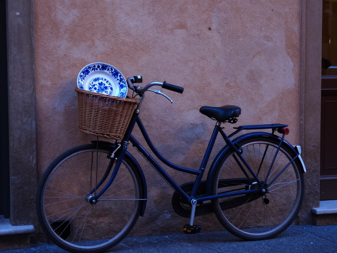 Bicycle Basket and Vintage Majolica Plate in Bologna Evening Blue Light in in Bologna, Italy