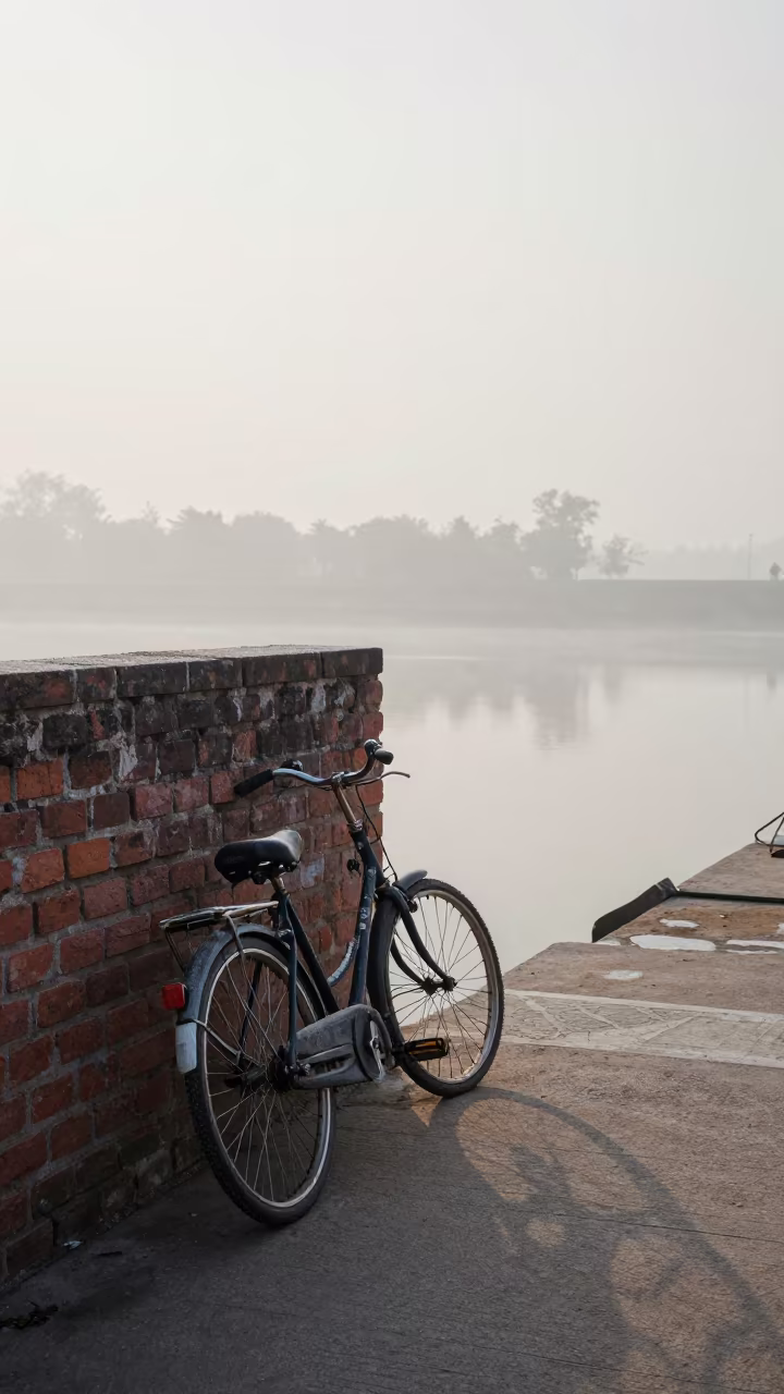 Bicycle Wheel Shadows on Brick Wall at Dawn in beside a fogbound harbor mouth in Haryana