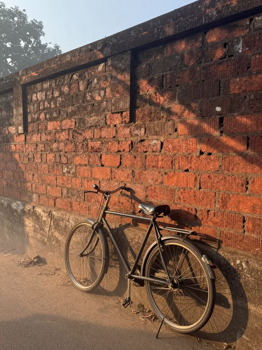 Bicycle Wheel Shadows on Brick Wall in on a wind-open causeway in Maharashtra