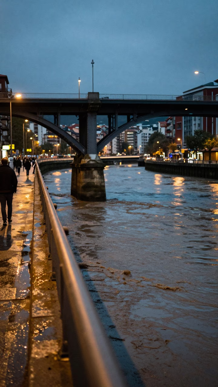 Bilbao Spain Evening Street Scene with Bridge Pier and Muddy Water in in Bilbao, Spain