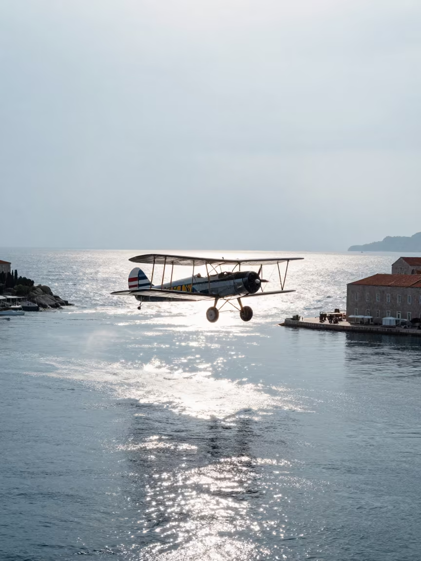 Biplane Flying Over Harbor Channel in Rain in near Dubrovnik