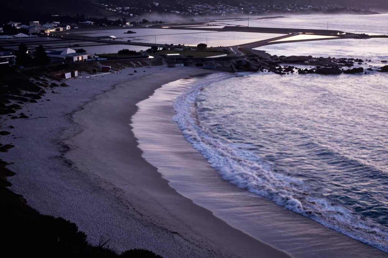 Black Sand Beach Aerial View Cape Town Twilight in high over salt ponds and causeways near Cape Town