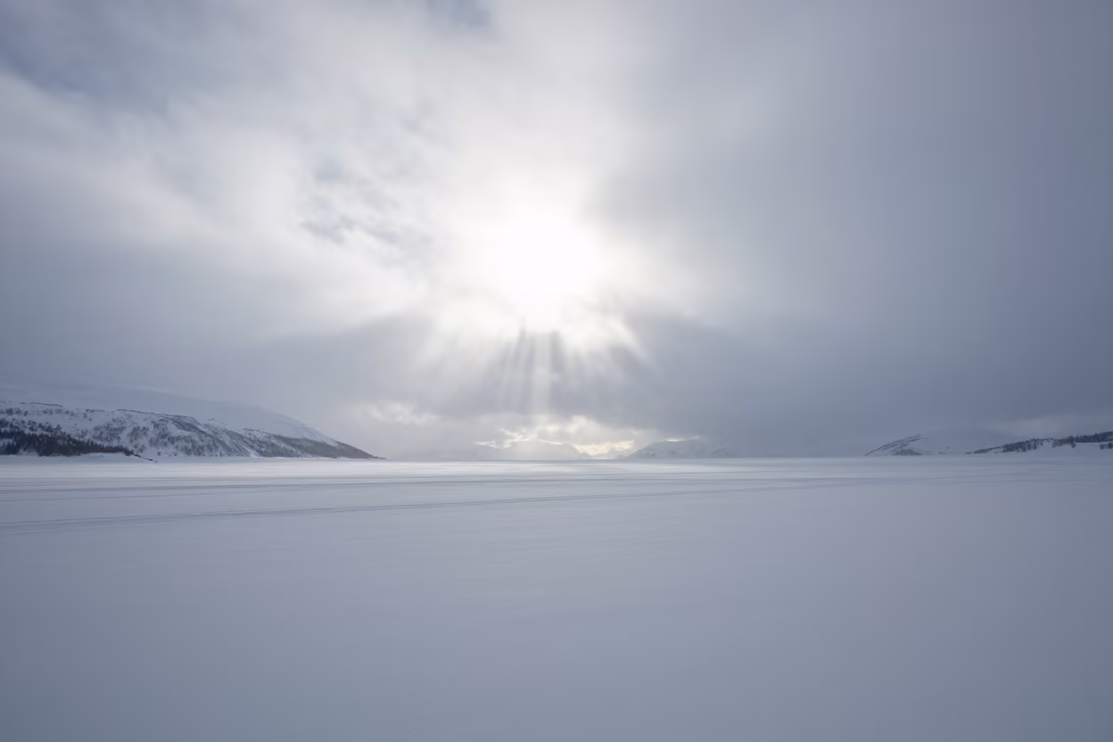 Blizzard Whitening Alaska Coastal Landscape Midday in beneath fast-moving cloud bands in Alaska