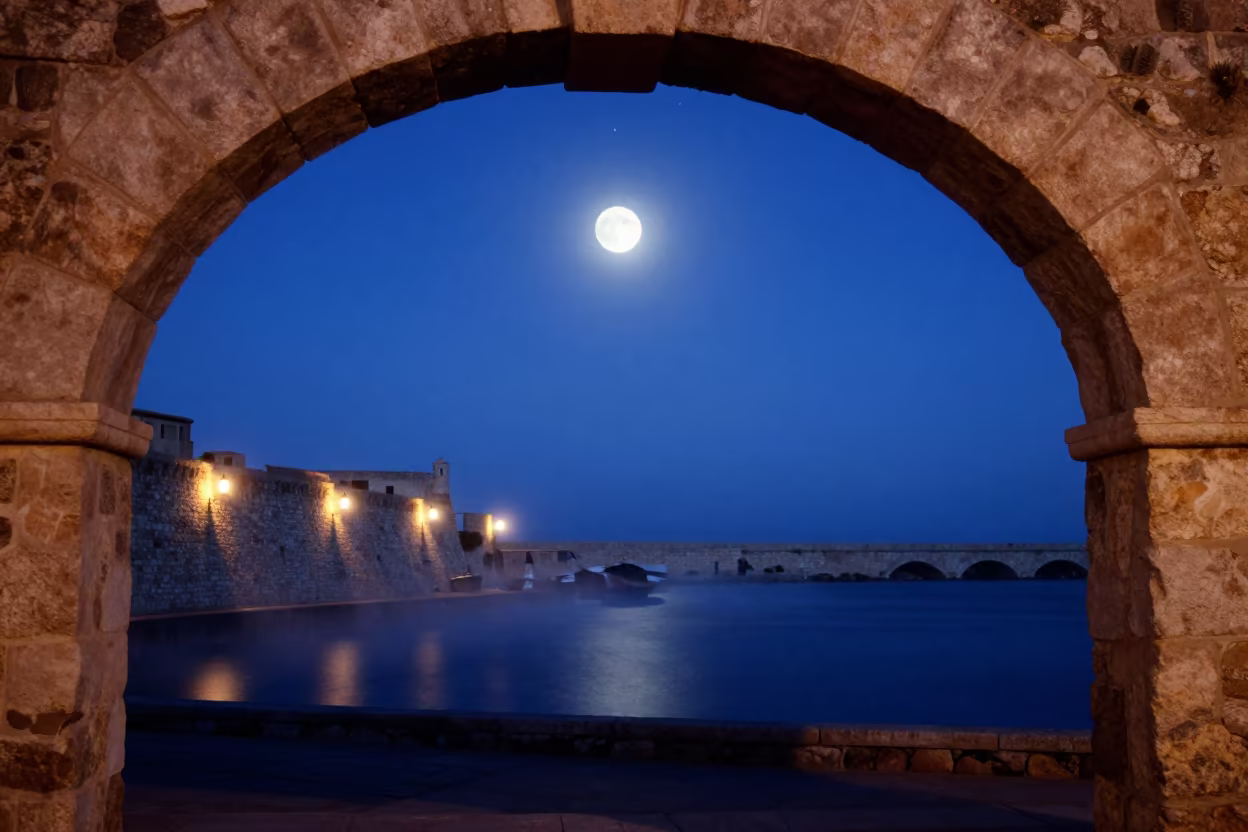 Blood Moon Over Sardinian Harbor in Twilight in beside a lantern-dotted harbor in Sardinia