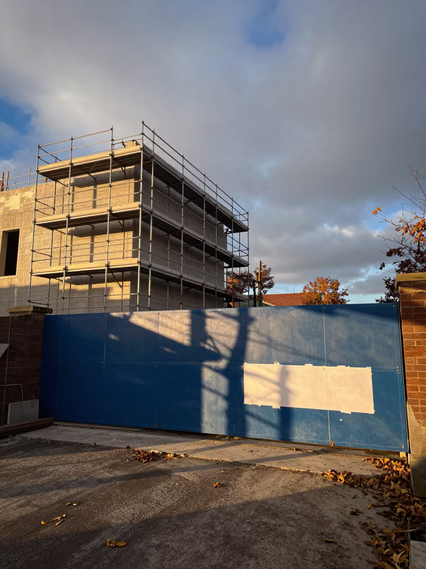 Blue Dawn Scaffold Gate Medina Construction in beside a framed building shell near Medina