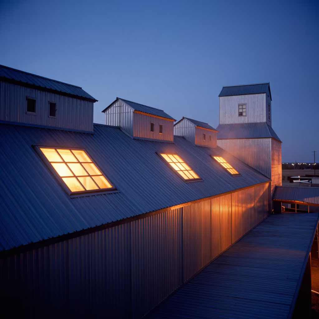 Blue Dusk Over Grain Elevator Sawtooth Roof in inside a grain elevator near Lakota