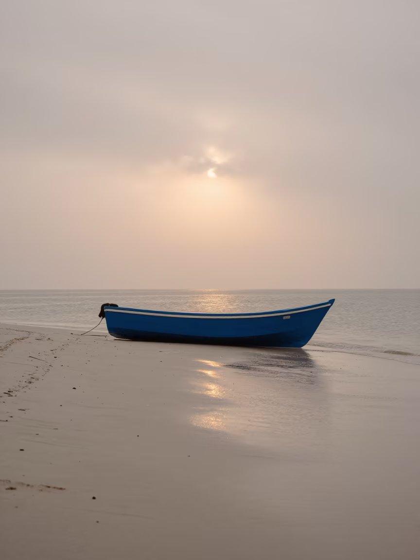 Blue Fishing Boat on White Sand Before Sunrise in on a wind-open causeway in Peru