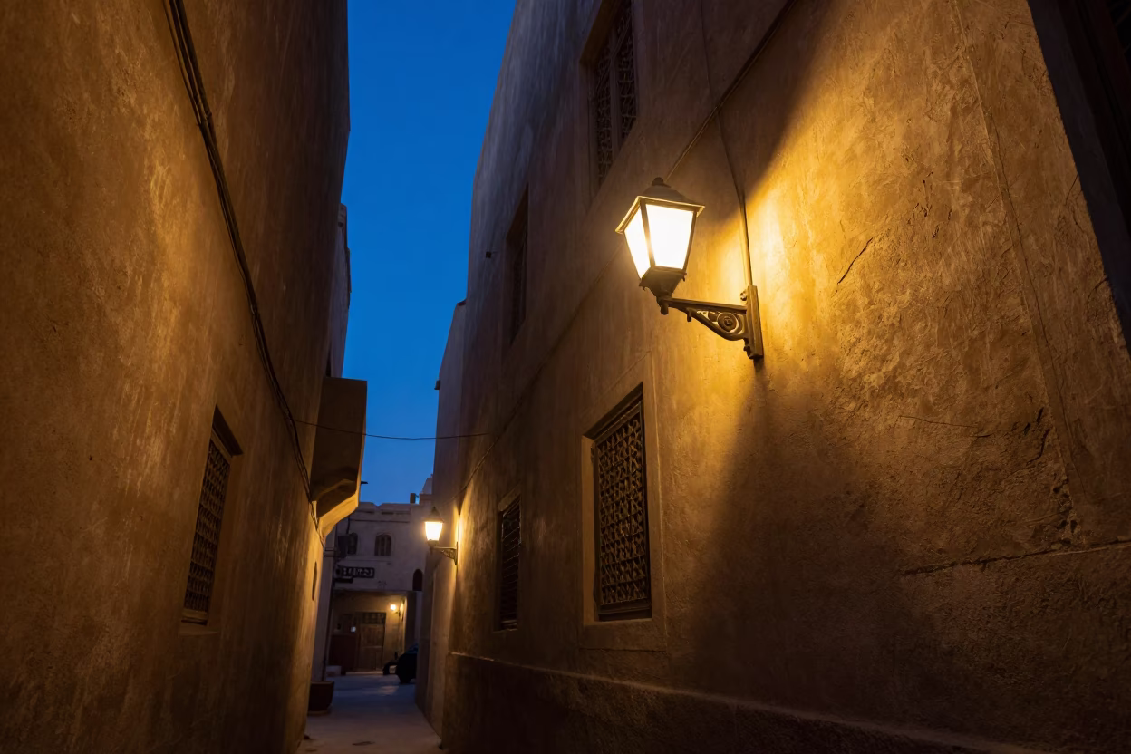 Blue Hour Cairo Street Scene with Vintage Wall Sconce Illuminating Narrow Alleyway in in Cairo, Egypt