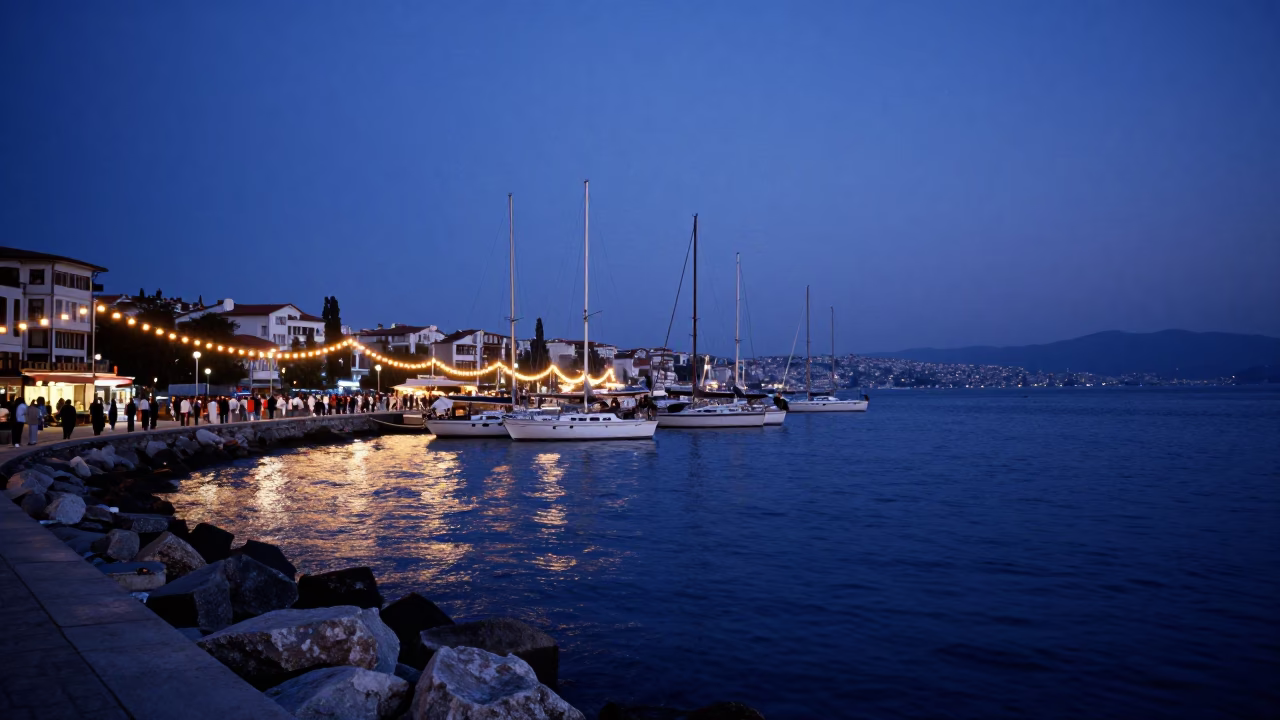 Blue Hour Evening in Izmir Harbor with String Lights and Sailing Boats in in Izmir, Turkey