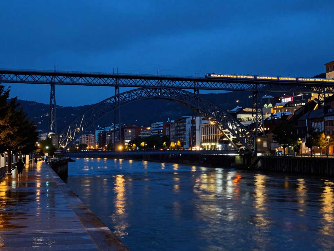 Blue Hour in Bilbao Spain Night Train Crossing Floodlit Iron Bridge Over Nervion River in in Bilbao, Spain