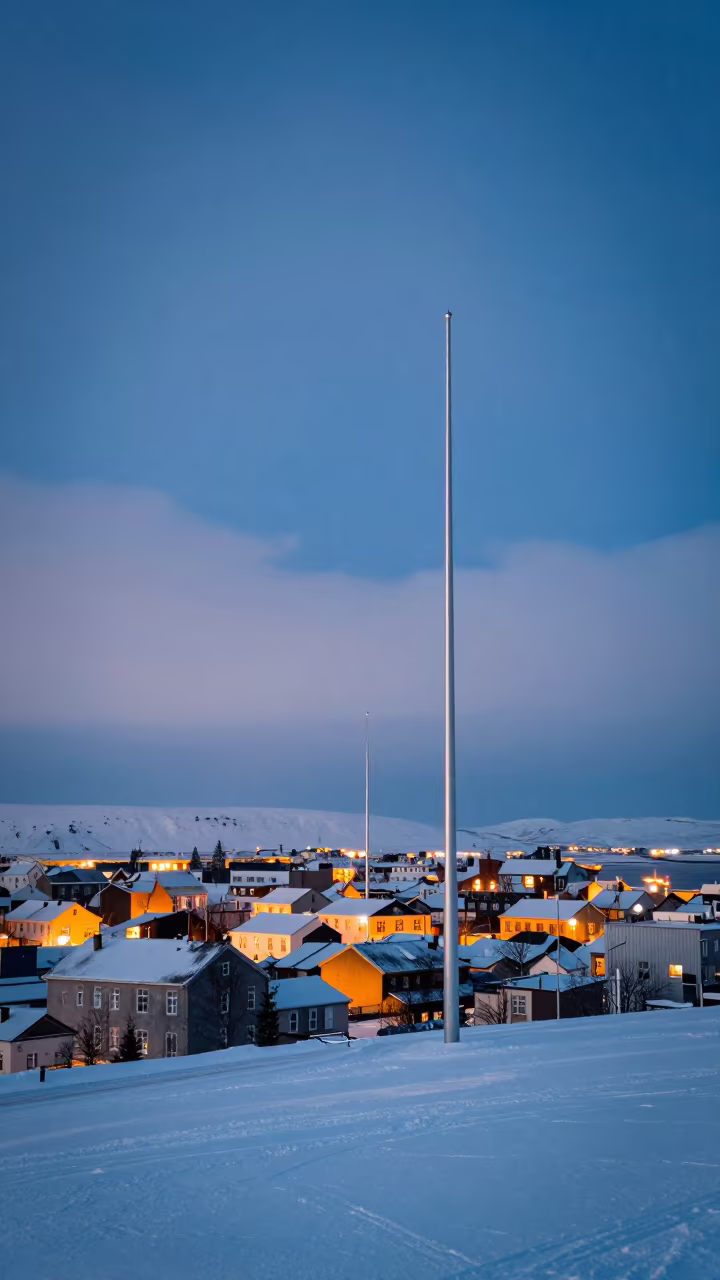 Blue Hour Light Pillars Over Frozen Grandi Town in beneath fast-moving cloud bands near Grandi, Reykjavik