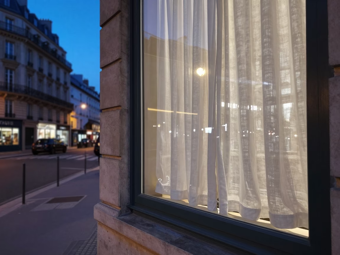 Blue Hour Paris Street Scene with Linen Curtains and Folded Outdoor Seating in in Paris, France