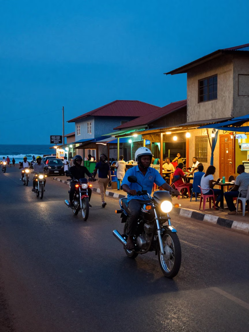 Blue Hour Street Scene in Accra Ghana with Motorcycle and Local Dining in in Accra, Ghana