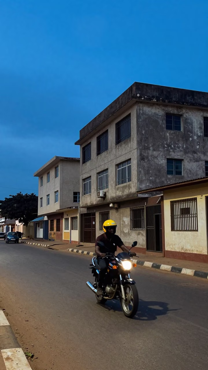 Blue Hour Street Scene in Accra Ghana with Motorcyclist and Urban Infrastructure in in Accra, Ghana
