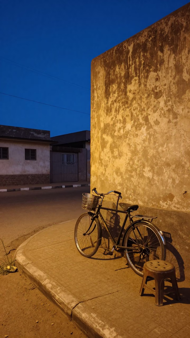 Blue Hour Street Scene in Dakar Senegal with Vintage Bicycle and Stool in in Dakar, Senegal