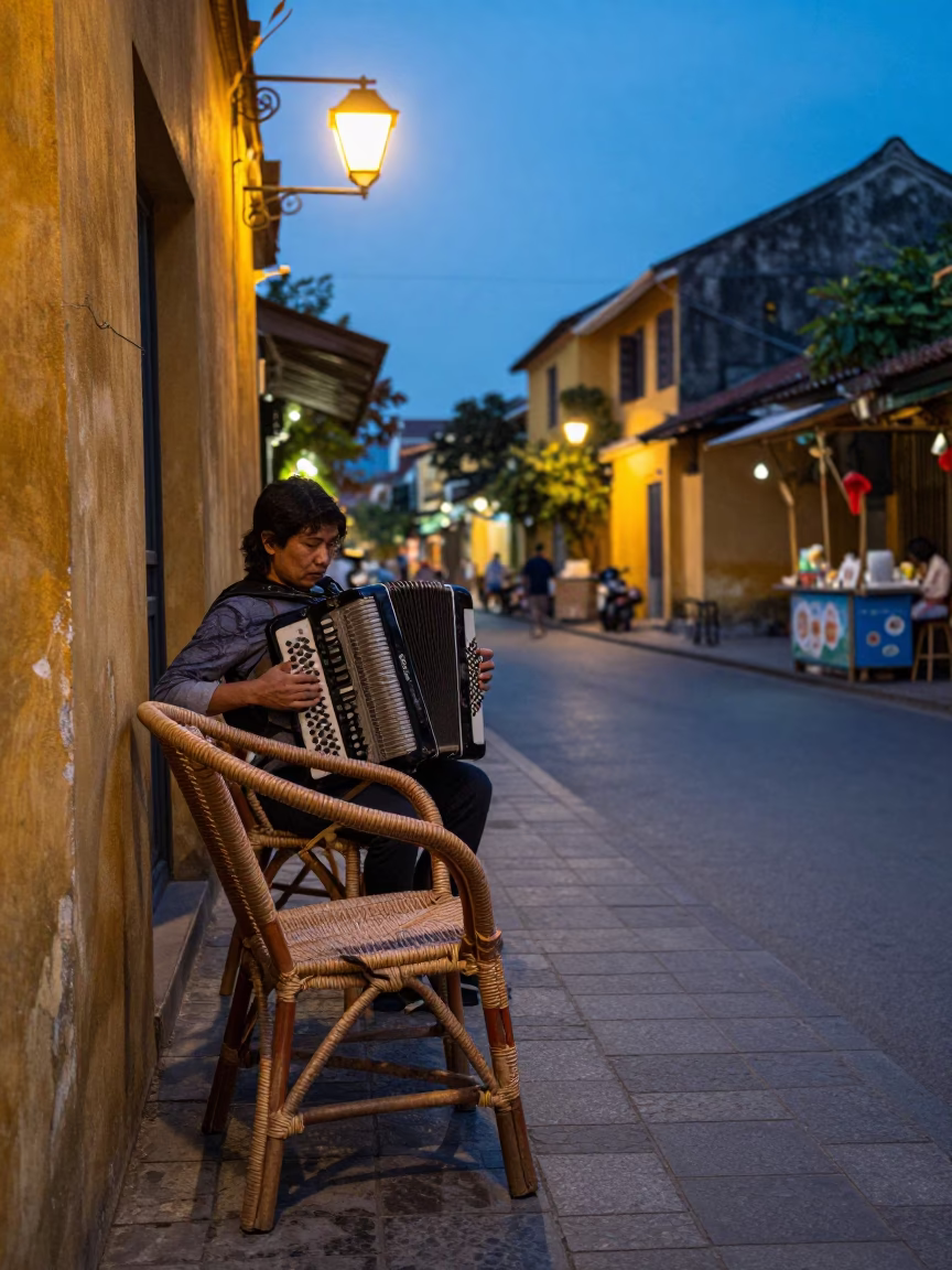 Blue Hour Street Scene in Hoi An Vietnam with Rattan Chair and Accordion Musician in in Hoi An, Vietnam