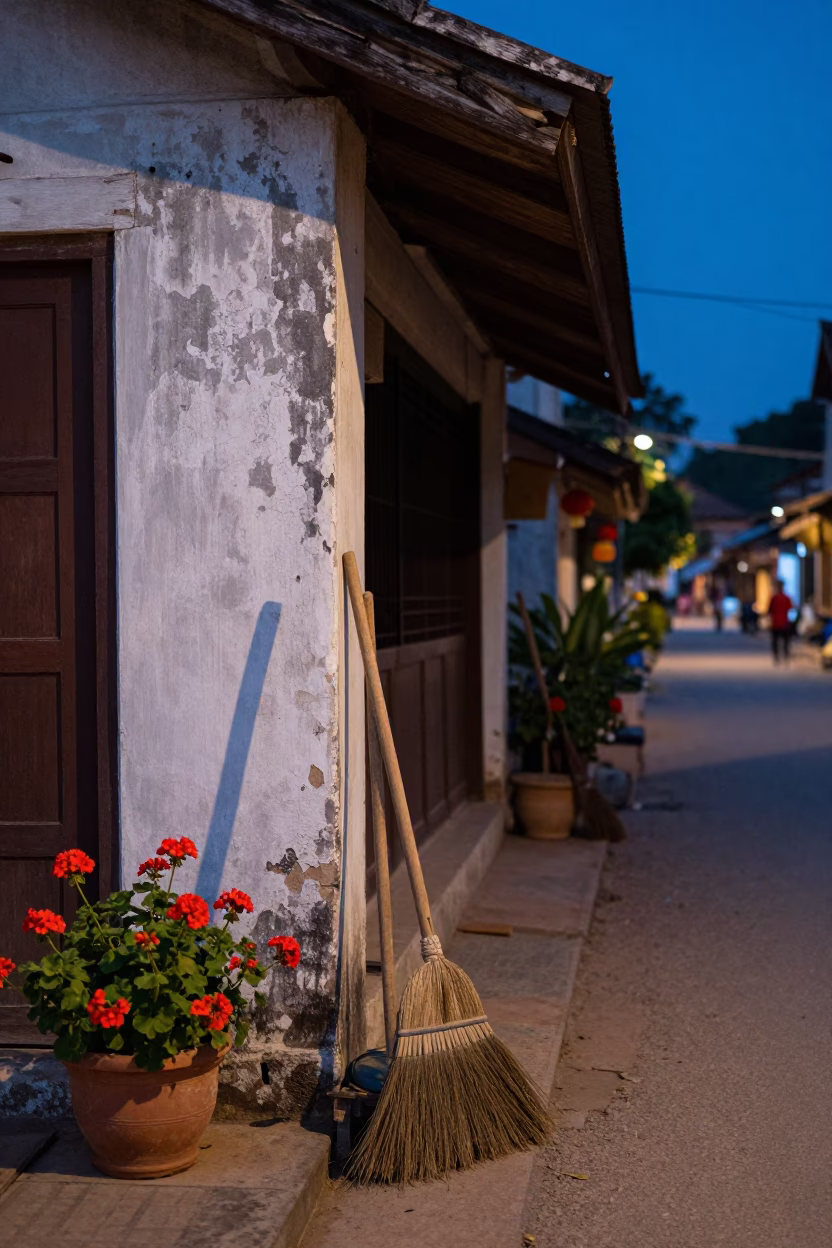 Blue Hour Street Scene in Luang Prabang Laos with Brooms and Geraniums in in Luang Prabang, Laos